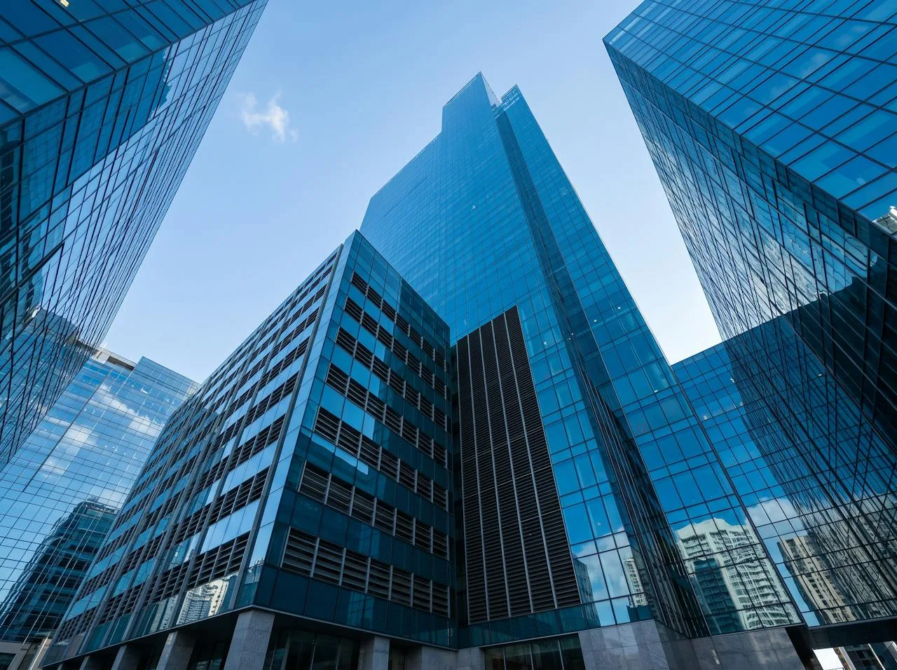 Glass office towers against a clear blue sky